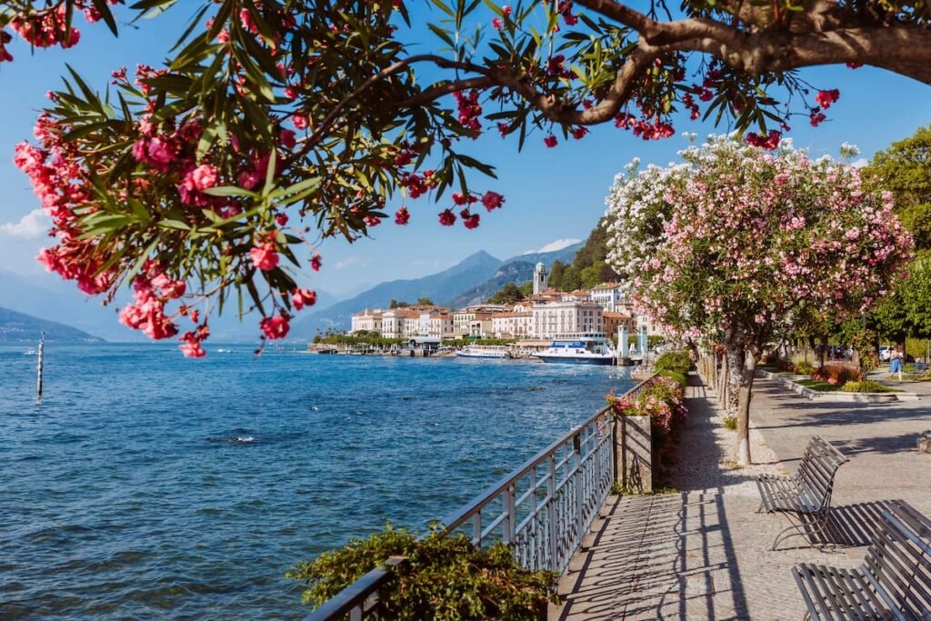 Bellagio lakeside promenade with flowers and panoramic Lake Como view