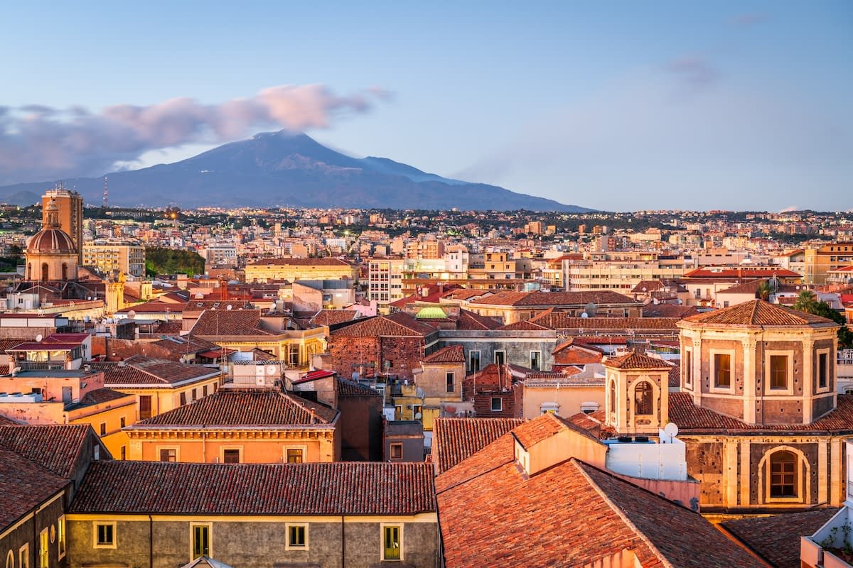 Catania’s historic rooftops with Mount Etna in the background during a Sicily tour