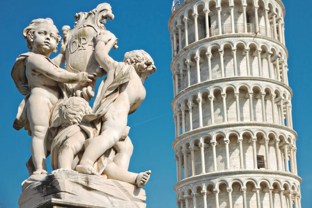 Sculptural detail with the Leaning Tower of Pisa in the background