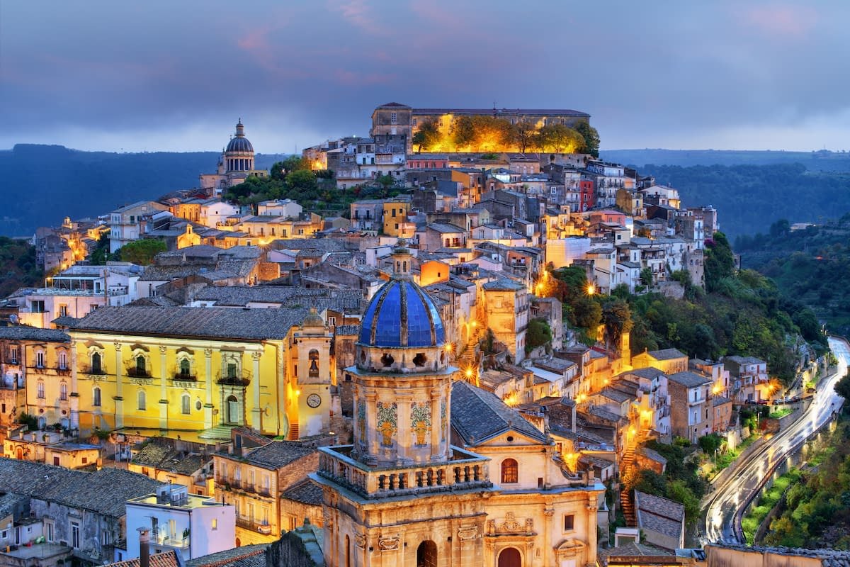 A Sicilian hill town at dusk as the main tour begins